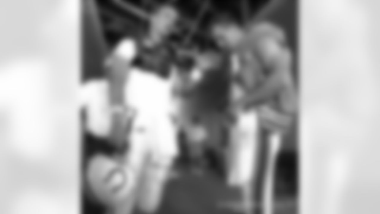 Cleveland Browns quarterback Tim Couch, right, and Indianapolis Colts quarterback Peyton Manning talk while preparing to enter the field for a combined practice at Columbus Crew Stadium on Saturday, July 22, 2000, in Columbus, Ohio. (AP Photo/Jay LaPrete)