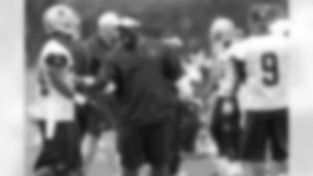 Running backs coach Gary Brown works with RB Phillip Tanner during OTAs.