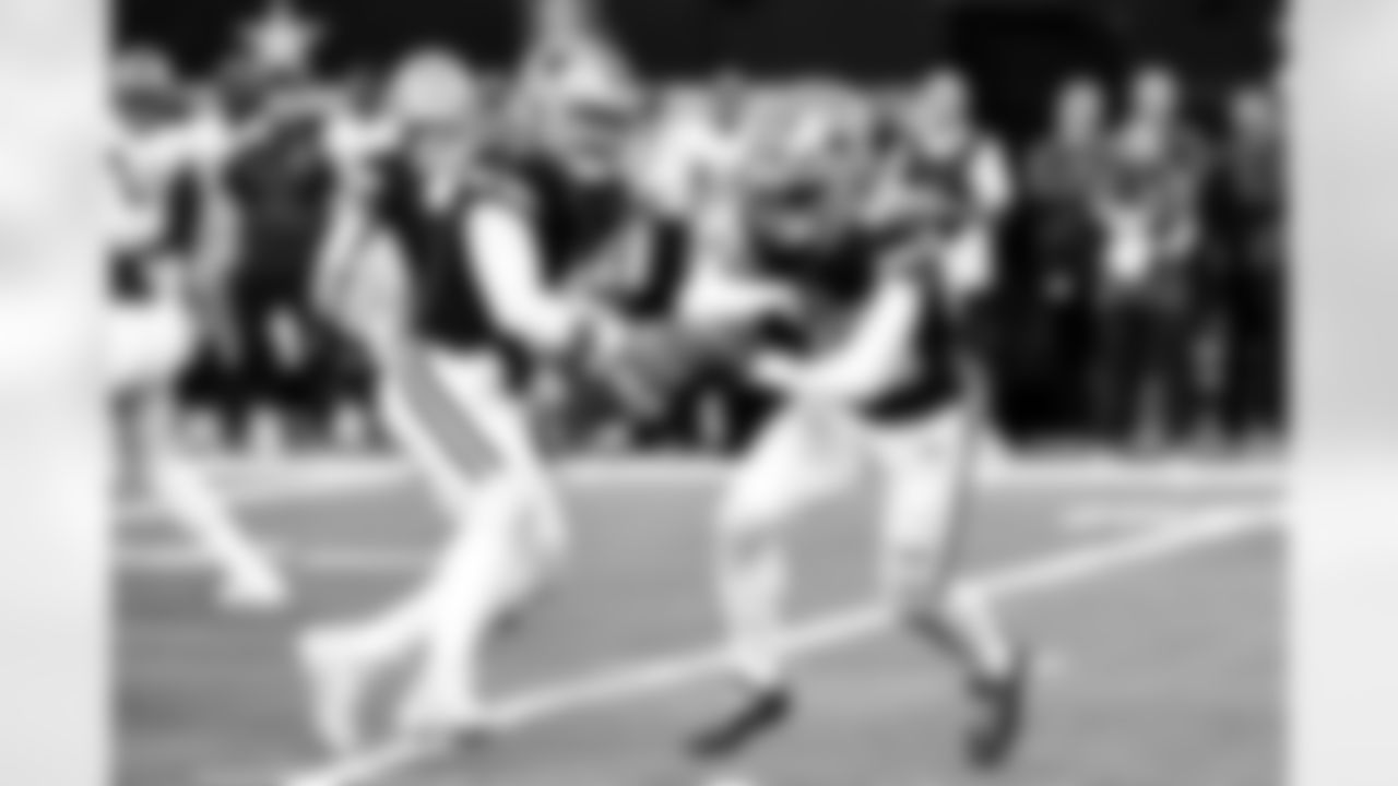 Dallas Cowboys quarterback Dak Prescott (4) fakes a handoff to running back Tony Pollard (20) during the first half of an NFL football game against the Los Angeles Rams, Sunday, Oct. 29, 2023, in Arlington, Texas. (AP Photo/Roger Steinman)
