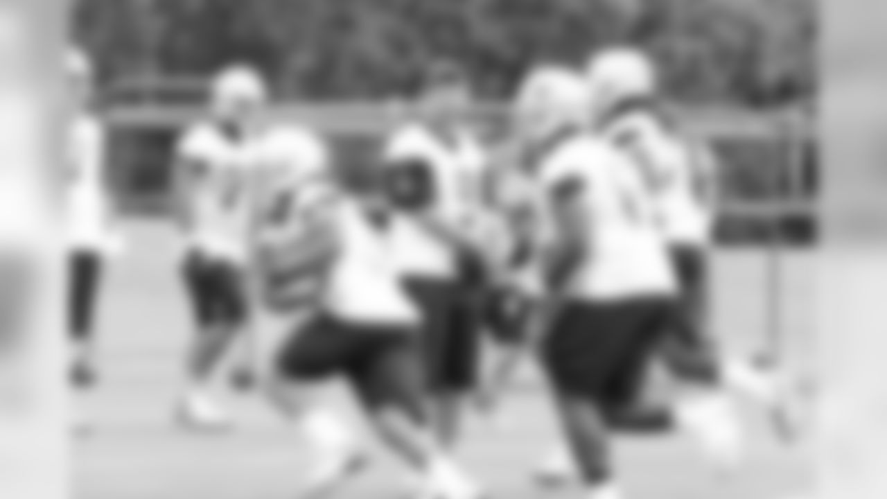 QB Tony Romo talks with WRs Miles Austin and Dez Bryant during OTAs at Valley Ranch.