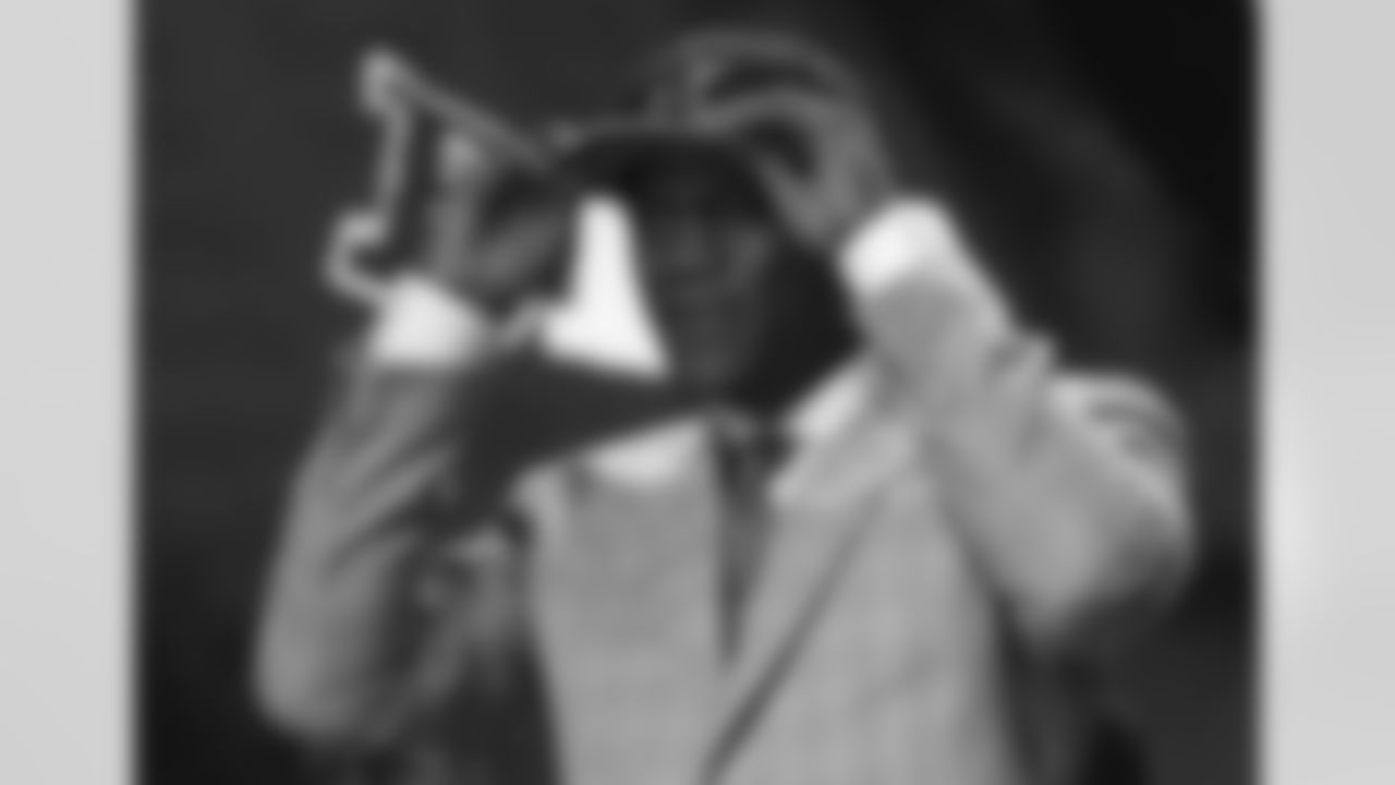 FILE - In this May 1, 2015, file photo, Nebraska defensive lineman Randy Gregory holds a Dallas Cowboys cap on his head after being selected by Dallas in the second round of the NLF football draft in Chicago. Gregory failed a marijuana test at the NFL scouting combine in February 2015 and later publicly acknowledged his use in college. Once considered a high first-round draft pick, he wasnt selected until late in the second round by Dallas. (AP Photo/Charles Rex Arbogast, File)
