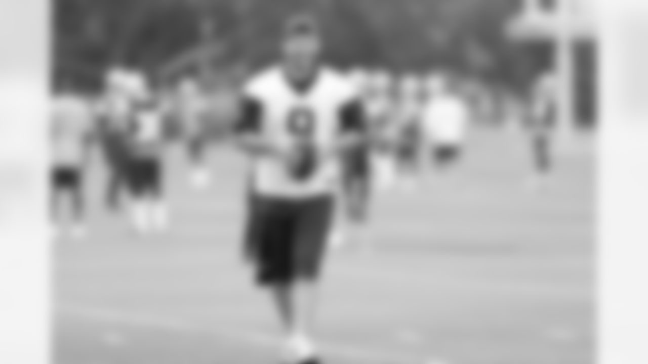 QB Tony Romo on the field during the first practice of OTAs.