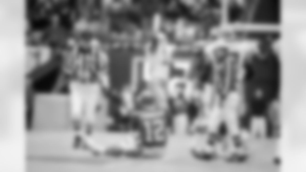 Philadelphia Eagles quarterback Randall Cunningham (12) sits dejected after being sacked by Dallas Cowboys? Jim Jeffcoat as Cowboys? Ken Norton celebrates in the background in the fourth quarter of NFC playoff game in Irving, Texas on Sunday, Jan. 10, 1993. The Cowboys won, 34-10. (AP Photo/Ron Heflin)