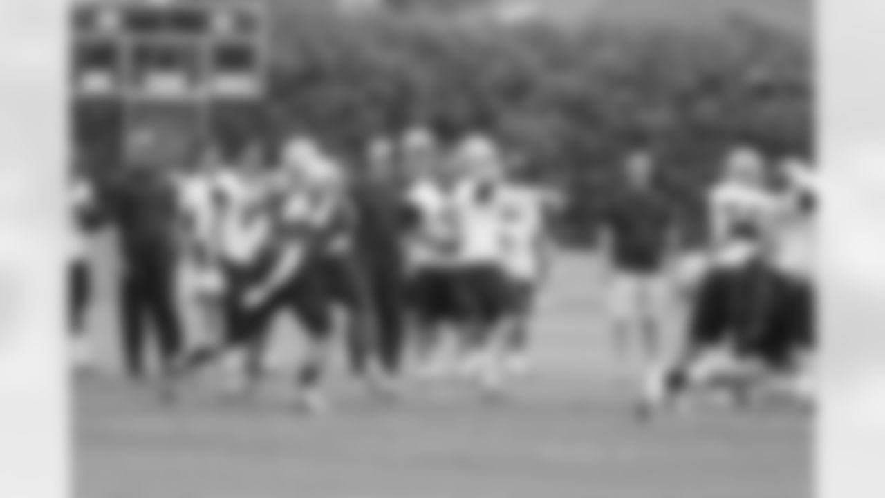 Jason Garrett and Tony Romo watch team drills during OTAs.