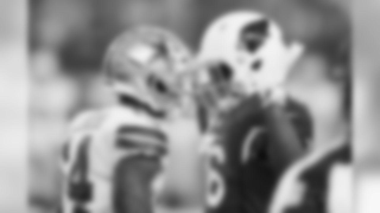 Dallas Cowboys wide receiver Lance Lenoir (14) and Arizona Cardinals wide receiver Trent Sherfield (16) stare down each other after a punt during the first half of a preseason NFL football game in Arlington, Texas, Sunday, Aug. 26, 2018. (AP Photo/Roger Steinman)