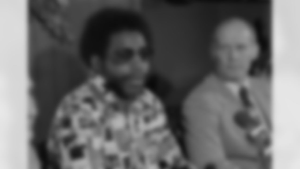 Dallas Cowboys coach Tom Landry, right, listens as d "Too Tall" Jones talks with the press after Jones was selected by Dallas in their first choice in the NFL draft, Jan. 29, 1974. The 6-foot-9-inch defensive lineman from Tennessee State was made available to Dallas in a trade with the Houston Oilers last season. (AP Photo)