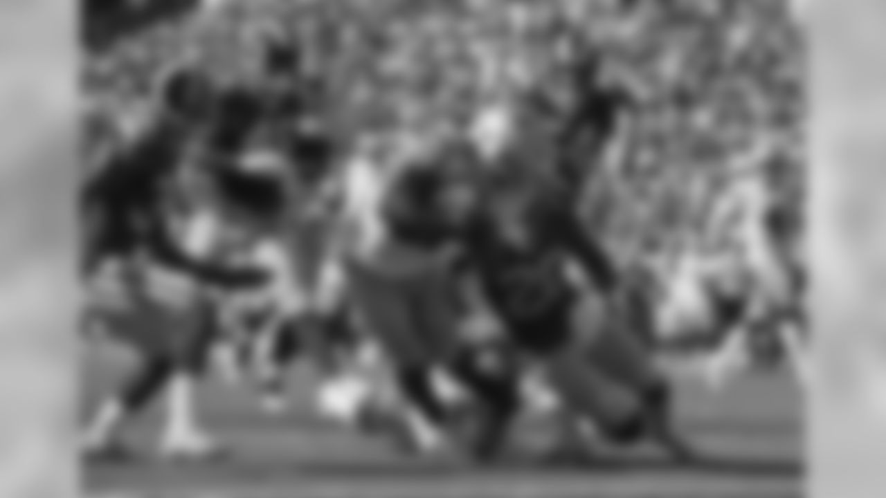 Dallas Cowboys running back Tony Pollard, center, runs in for a touchdown as Los Angeles Rams defensive back Marqui Christian, lower right, tries to tackle him during the first half of a preseason NFL football game Saturday, Aug. 17, 2019, in Honolulu. (AP Photo/Mark J. Terrill)