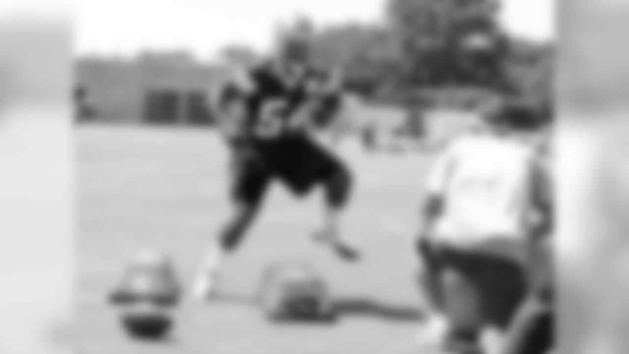 Bruce Carter runs through the bags during linebacker drills.