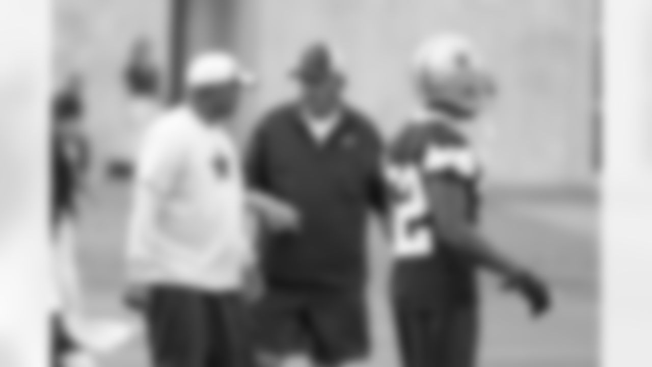 Defensive coordinator Monte Kiffen chats with Secondary coach Jerome Henderson.