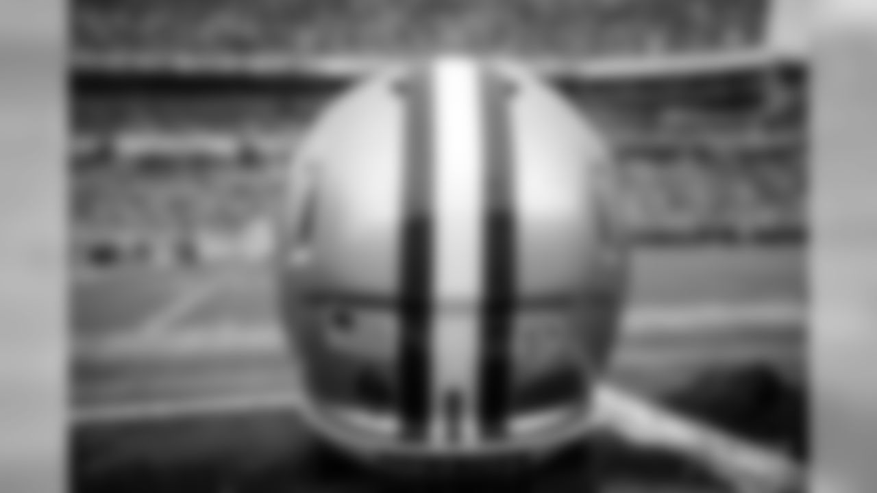 The helmet of NFC center Travis Frederick, of the Dallas Cowboys, sits on a locker behind the bench during the second half of NFL Pro Bowl football game Sunday, Jan. 28, 2018, in Orlando, Fla. The AFC won 24-23. A Walter Payton NFL Man of the Year decal is displayed on the back of the helmet. (AP Photo/Phelan M. Ebenhack)
