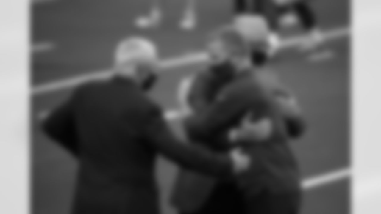 Dallas Cowboys team owner Jerry Jones, left, Stephen Jones, center rear, and New York Giants offensive coordinator Jason Garrett, right, greet each other before an NFL football game in Arlington, Texas, Sunday, Oct. 11, 2020. The game marks the first time Garrett has returned to play against the team he was the head coach of last season. (AP Photo/Michael Ainsworth)