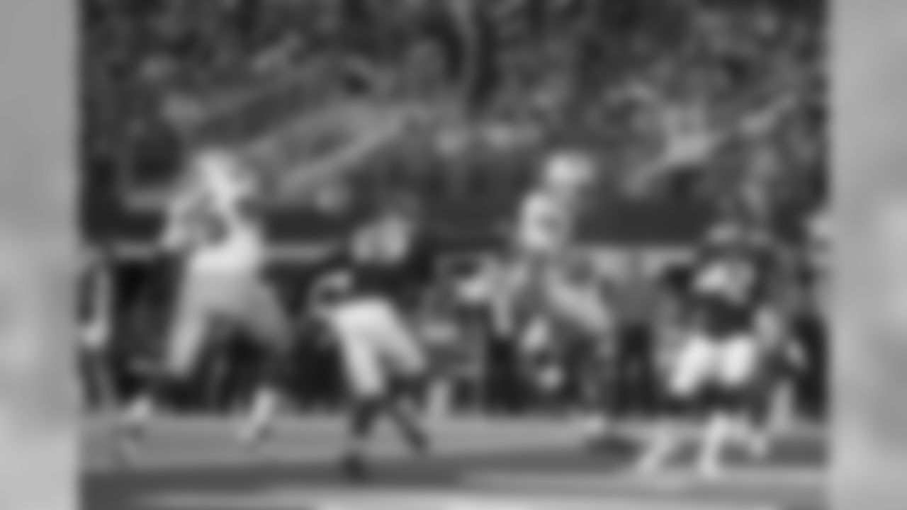 Dallas Cowboys running back Alfred Morris, second from right, tosses the ball in the air after running it for a touchdown as Cameron Fleming (75), Houston Texans' Jesse Aniebonam (69) and Lonnie Johnson (32) look on in the first half of a preseason NFL football game in Arlington, Texas, Saturday, Aug. 24, 2019. (AP Photo/Ron Jenkins)
