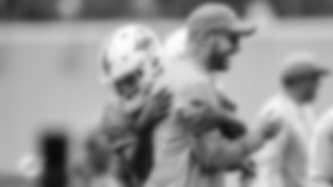 Miami Dolphins quarterback Tua Tagovailoa (1) and Miami Dolphins quarterbacks/passing game coordinator coach Darrell Bevell during an OTA Thursday, May 19th, 2022 in Miami Gardens, Fla. (Peter McMahon/Miami Dolphins via AP)
