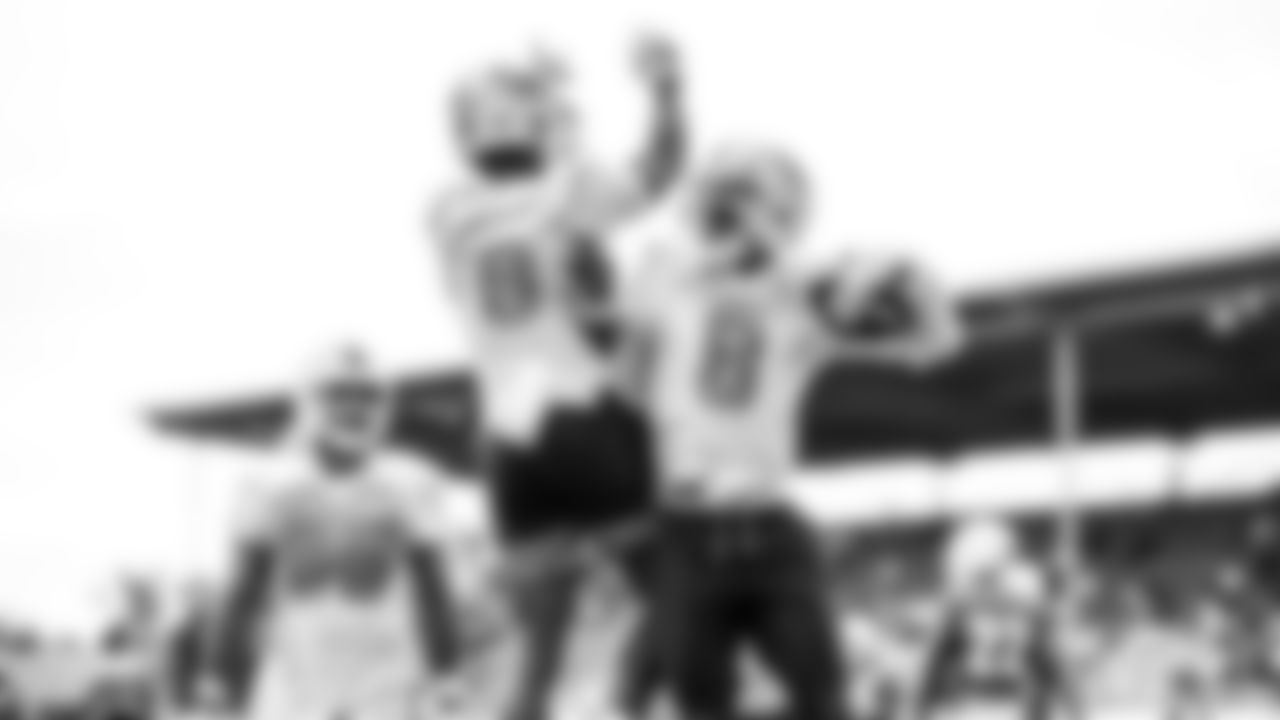 Miami Dolphins wide receiver Allen Hurns (8) catches a touchdown pass and celebrates with wide receiver Lynn Bowden Jr. (6) during training camp at the Baptist Health Training Complex on Monday, Aug. 2, 2021 in Miami Gardens, Fla. (Peter McMahon/Miami Dolphins via AP)