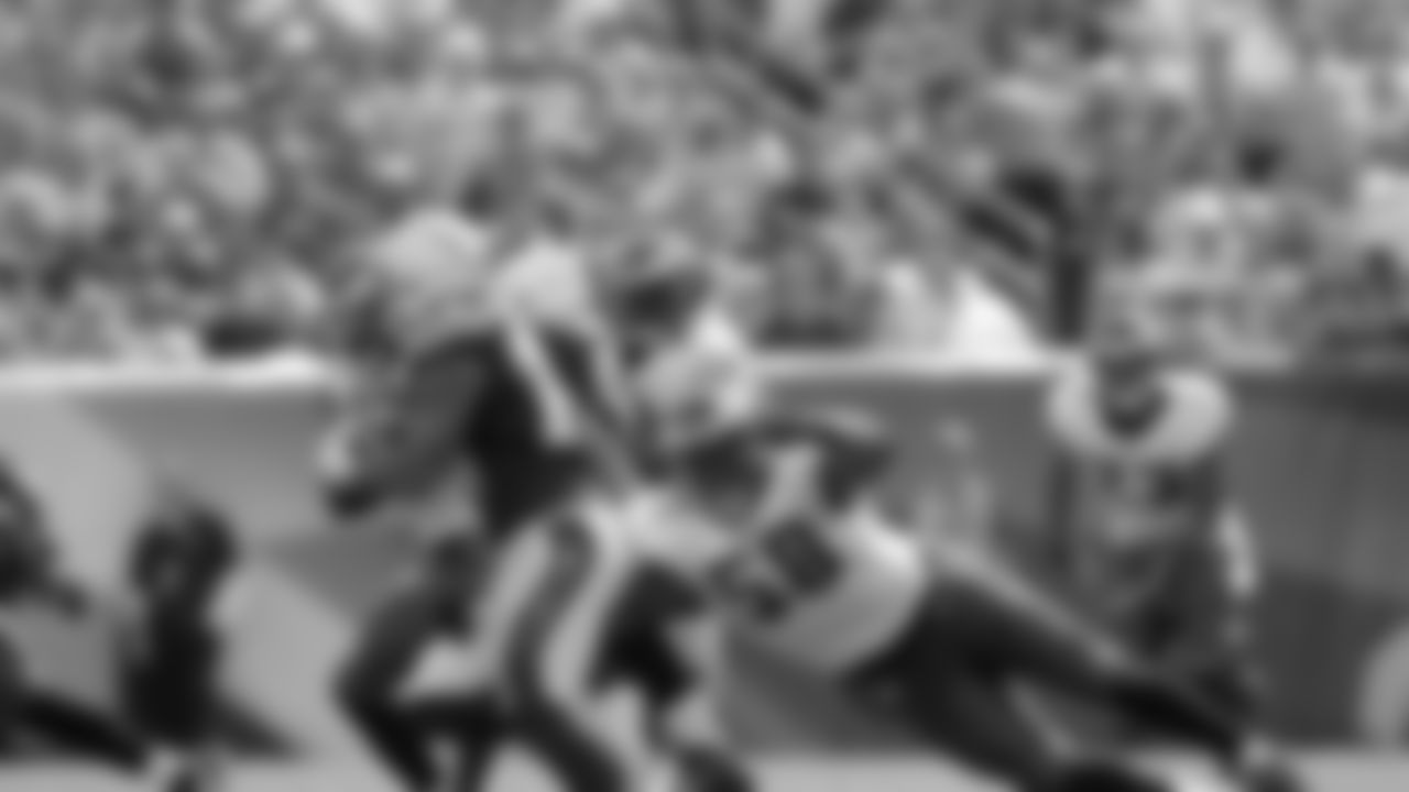 Eagles' linebacker Trent Cole puts his arms around Chargers' running back Ryan Mathews in Sunday's game.
