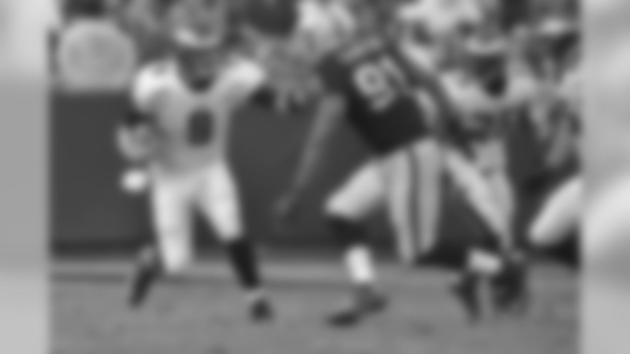 Eagles' QB Nick Foles stiff-arms Raiders DE Jack Crawford.