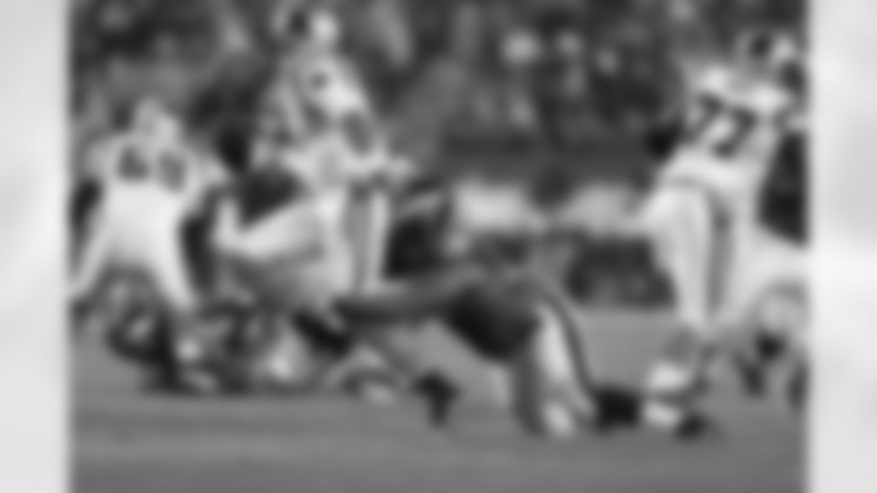 QB Cam Newton tries to escape from the Eagles' defender