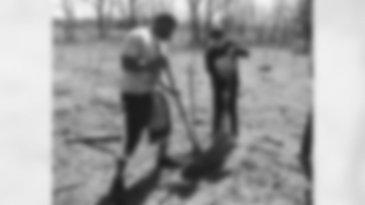 Akeem Jordan paired up with a student to plant trees to help offset the team's carbon emissions