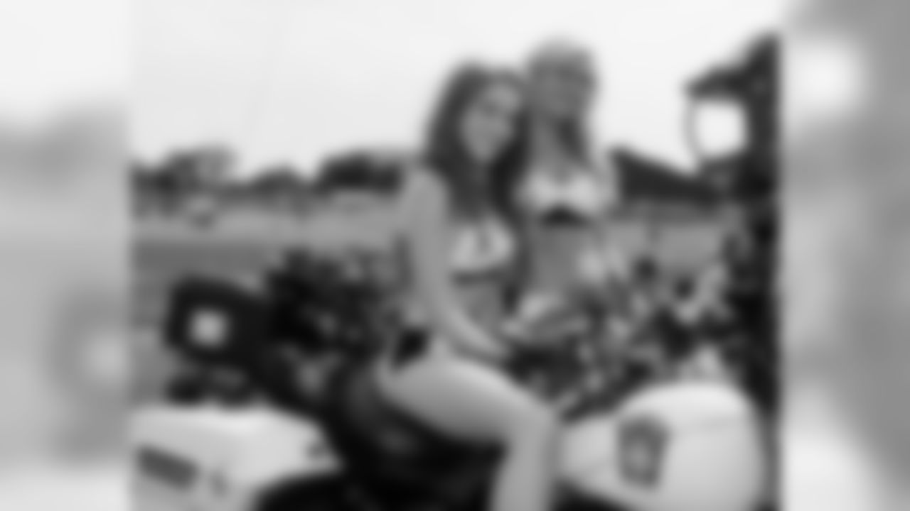 Cheerleaders Monica and Tracey are all smiles aboard and alongside a state trooper motorcycle