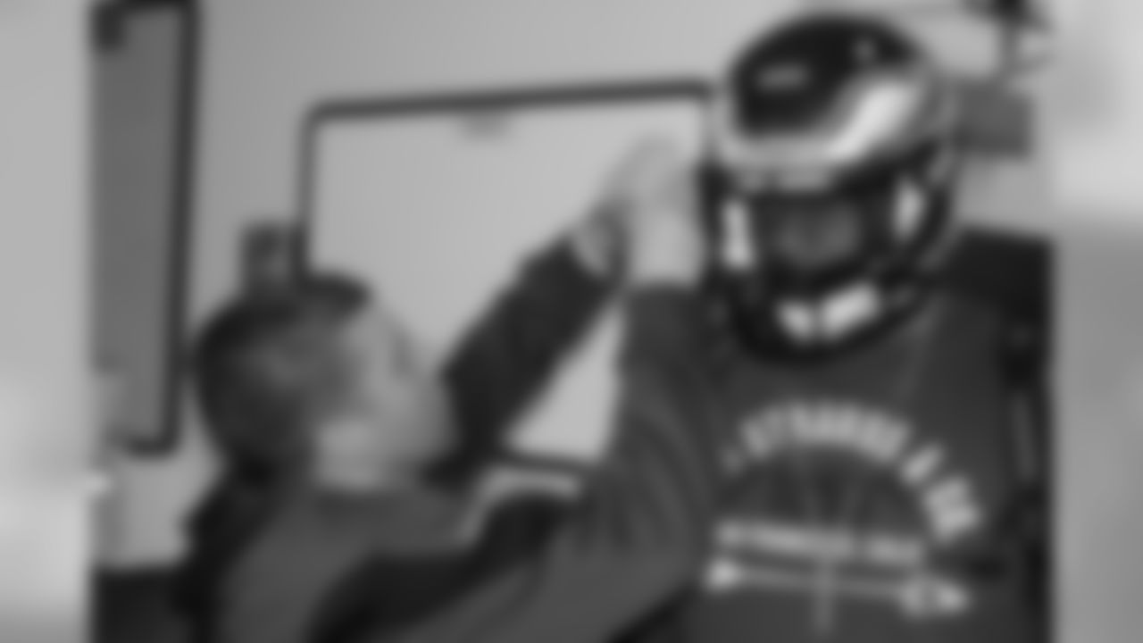 Some final tweaks are made to Fletcher Cox's helmet