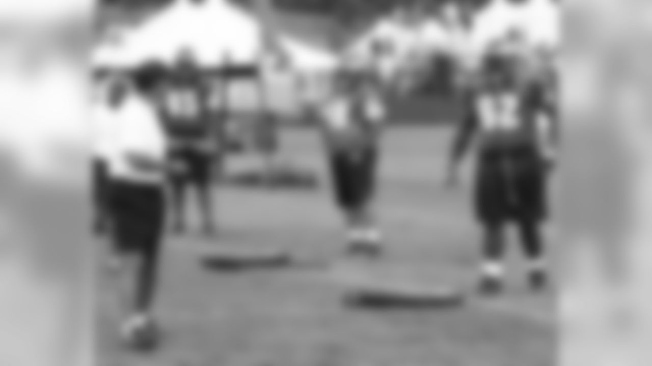Offensive line coach Juan Castillo instructs his players