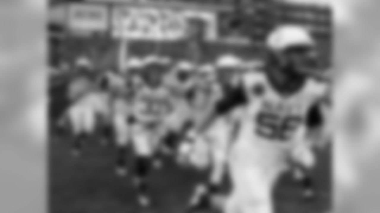 The Navy Midshipmen run out onto the field