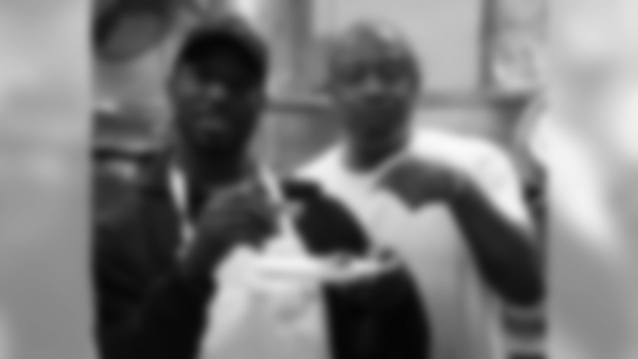 Avant tastes the good food with one of the cooks in the kitchen