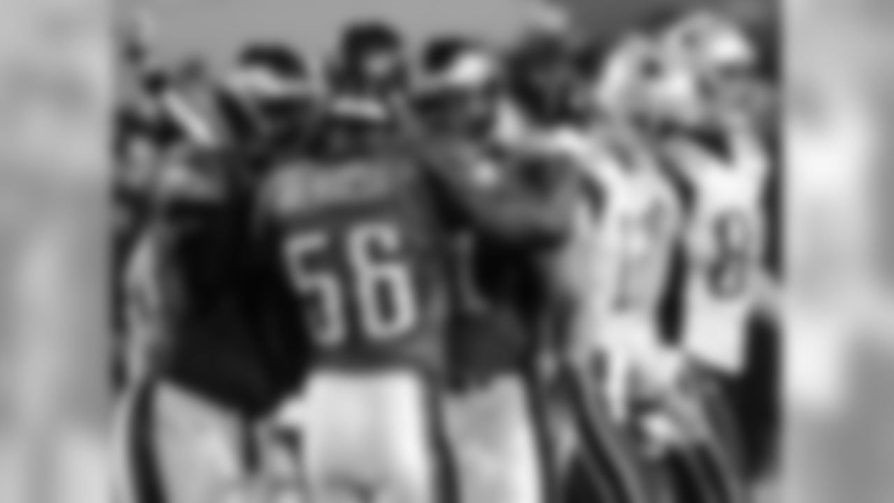 Linebacker Derrick Burgess celebrates sacking Brady with his teammates.