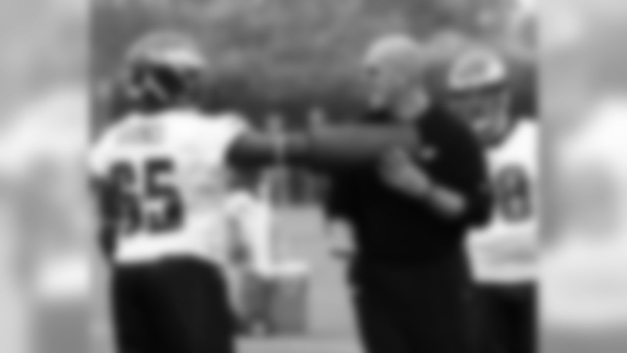 Defensive line coach Rory Segrest works with DE Josh Gaines