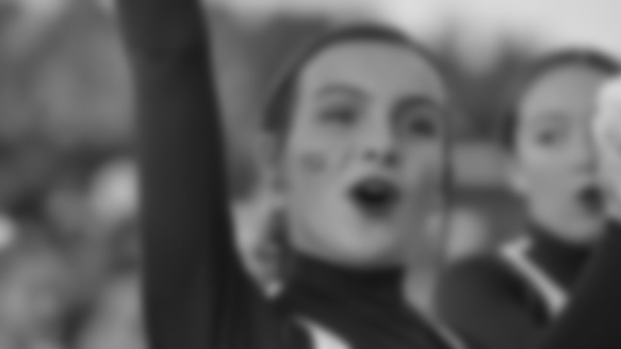 A Garnet Valley cheerleader pumps up the crowd while wearing an NFL100 sticker