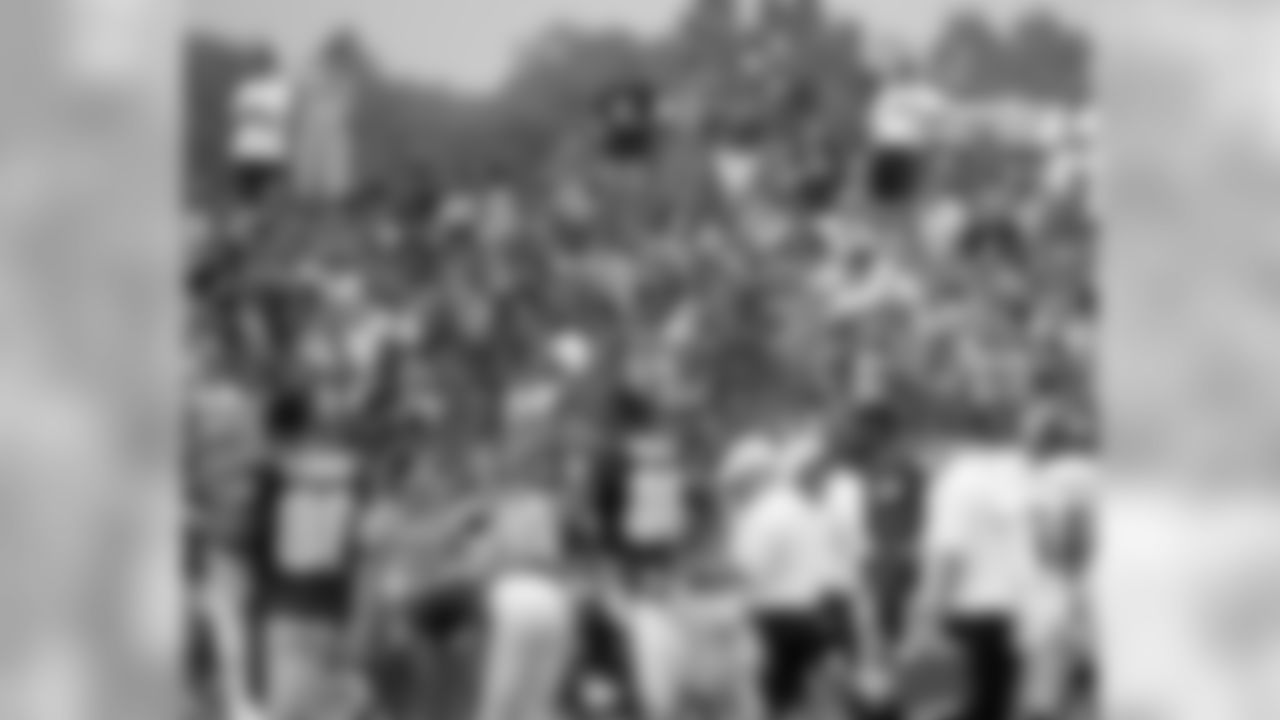 Fans looks on as Eagles go through training camp workout