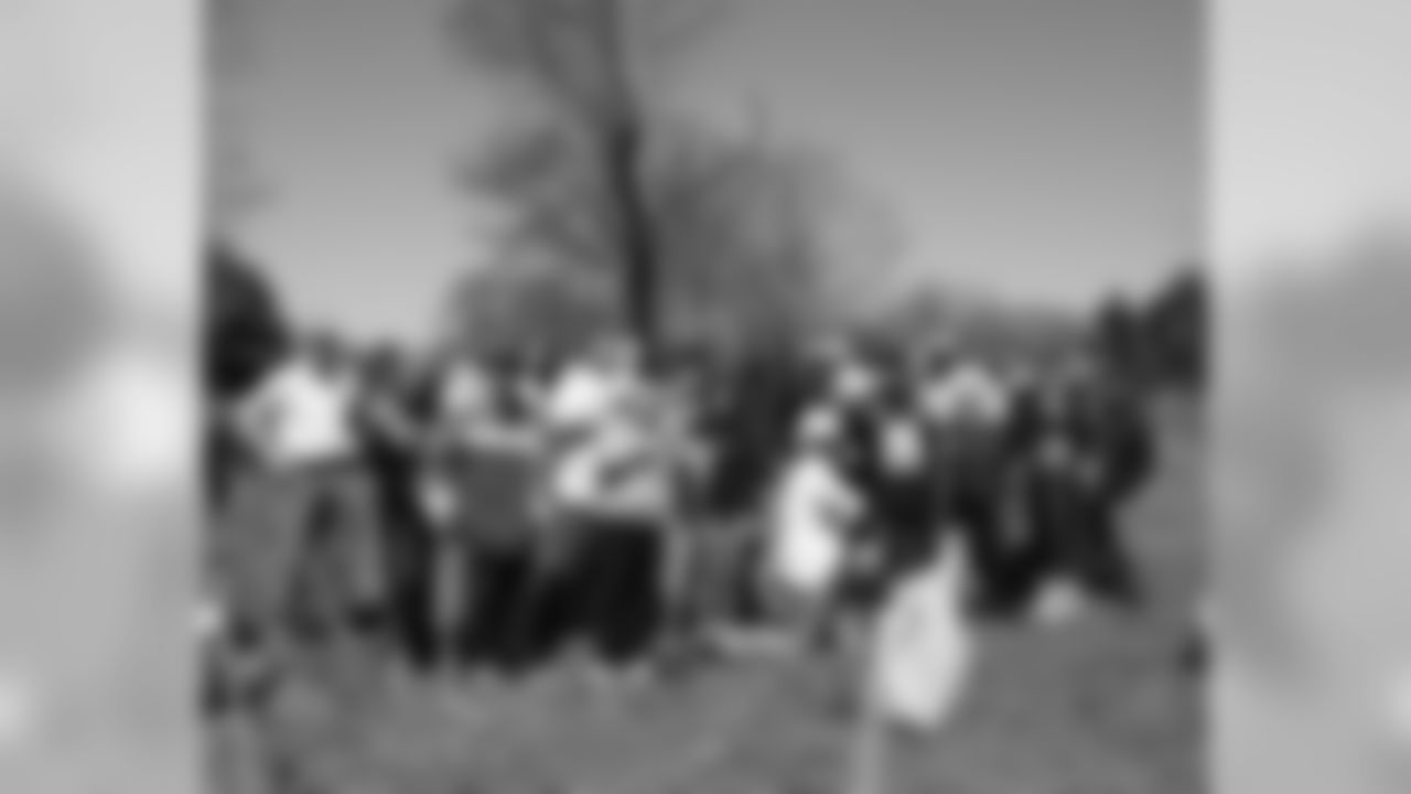 Fifteen students joined linebackers Akeem Jordan and Joe Mays to plant trees at the Eagles Forest