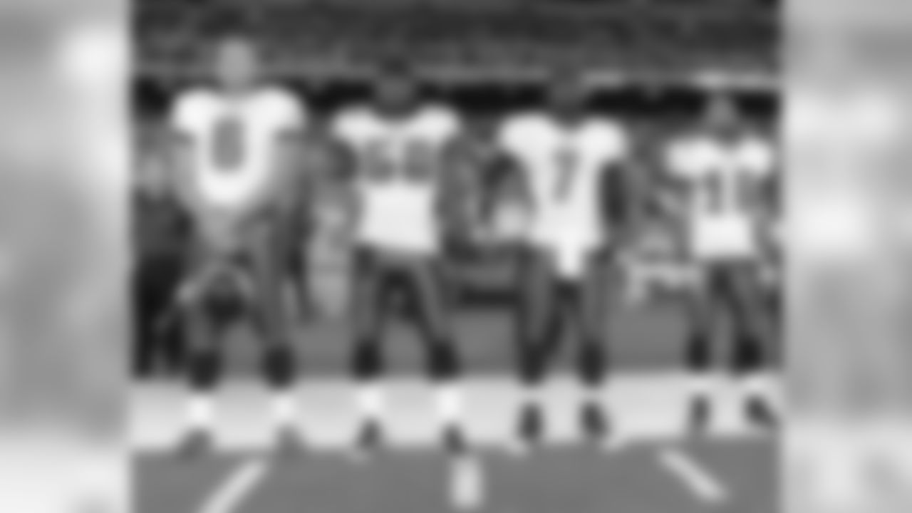 Team captains, P Rocca, LB Simms, QB Vick and WR Jackson