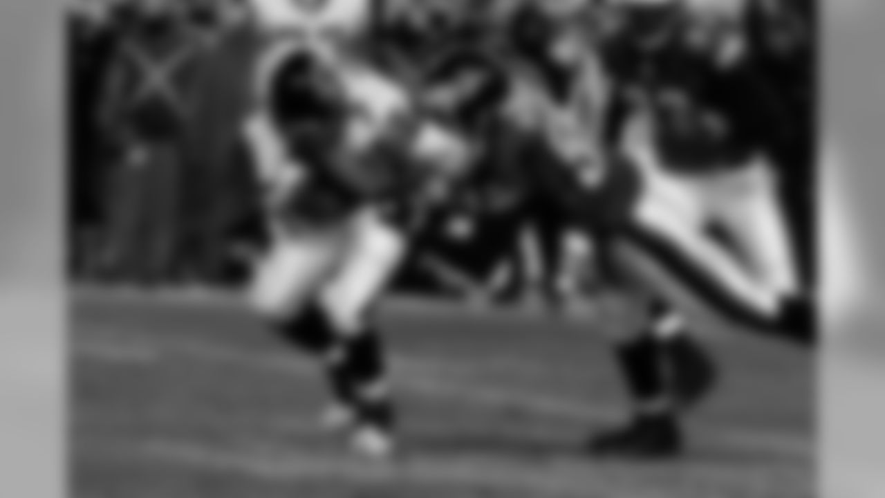 DE Derrick Burgess goes for the tackle