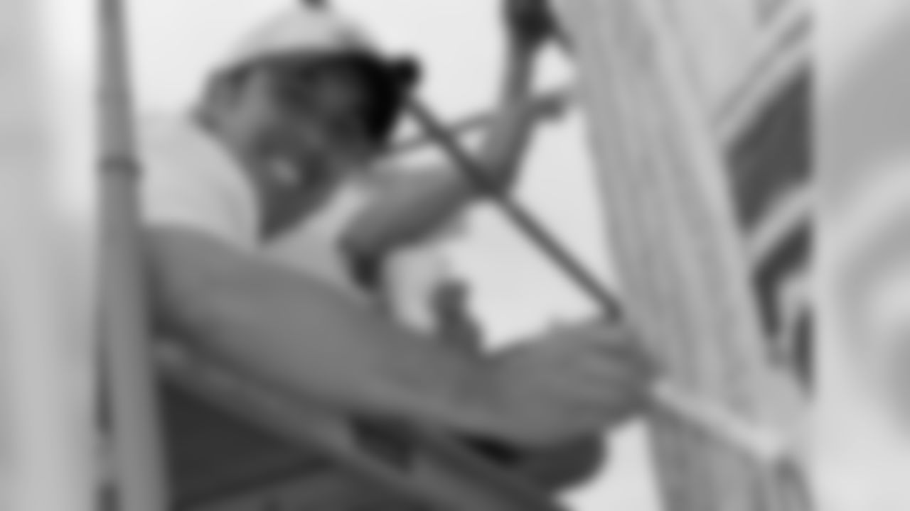 Dave Krueger goes up high to work on the mural