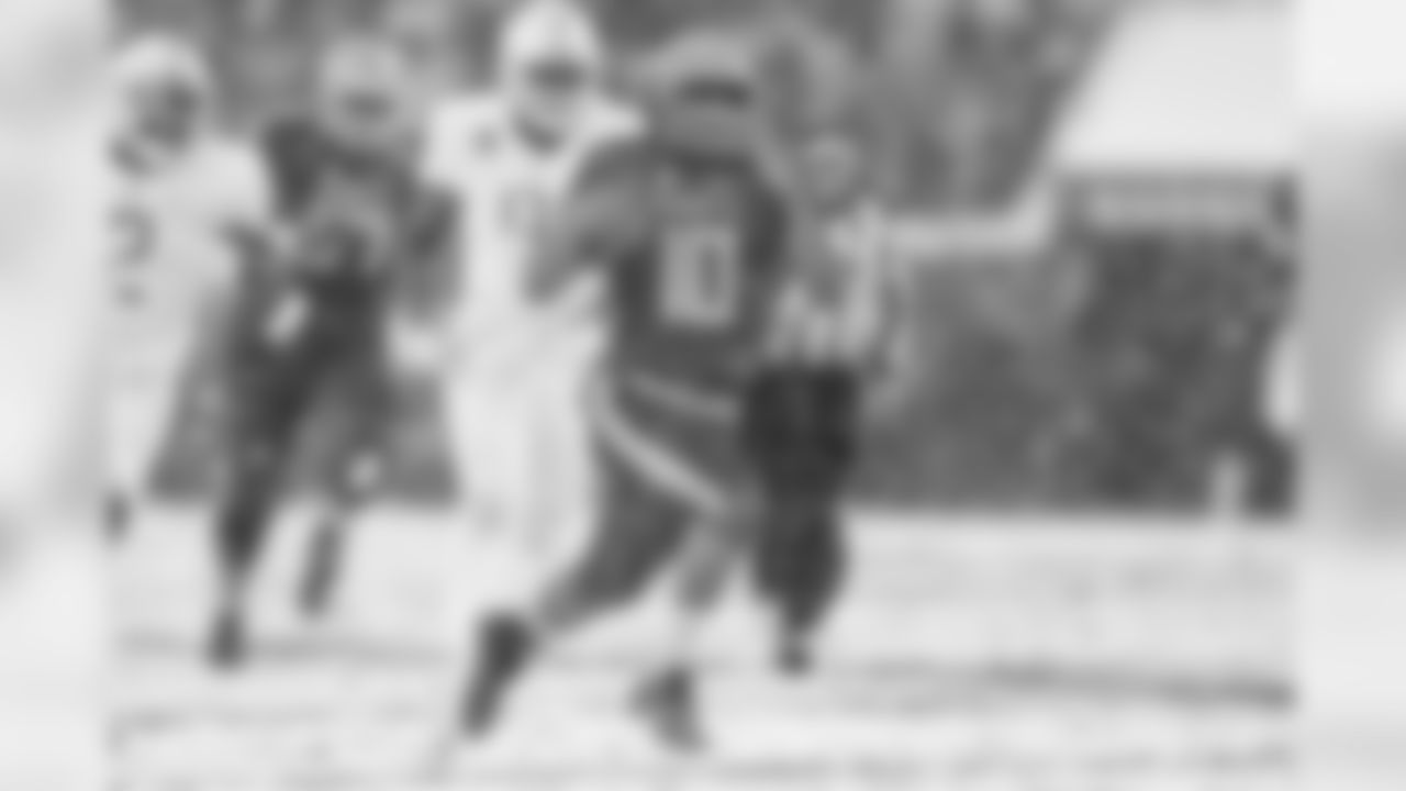 Navy QB Malcolm Perry runs through the Army defense.