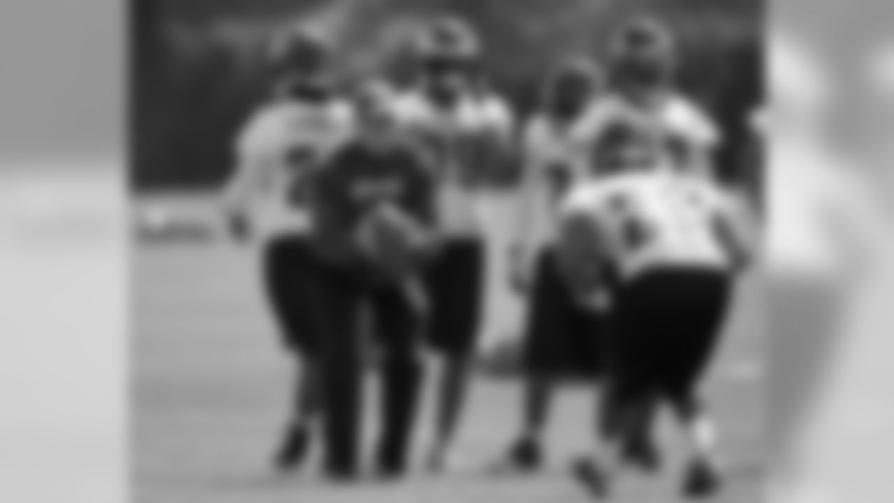 DBs coach Dick Jauron works with his troops