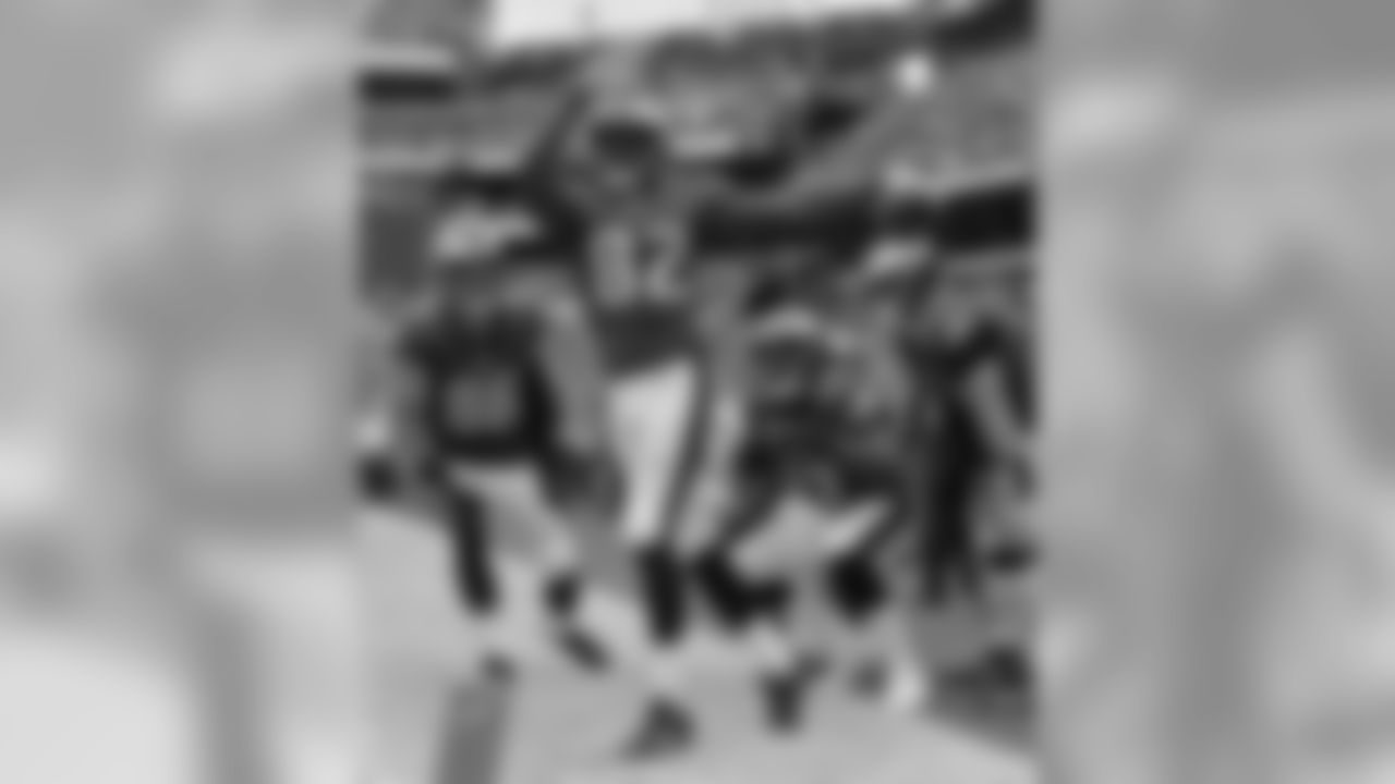 His teammates look on as Smith knocks one right out of Lincoln Financial Field in front of the fans.