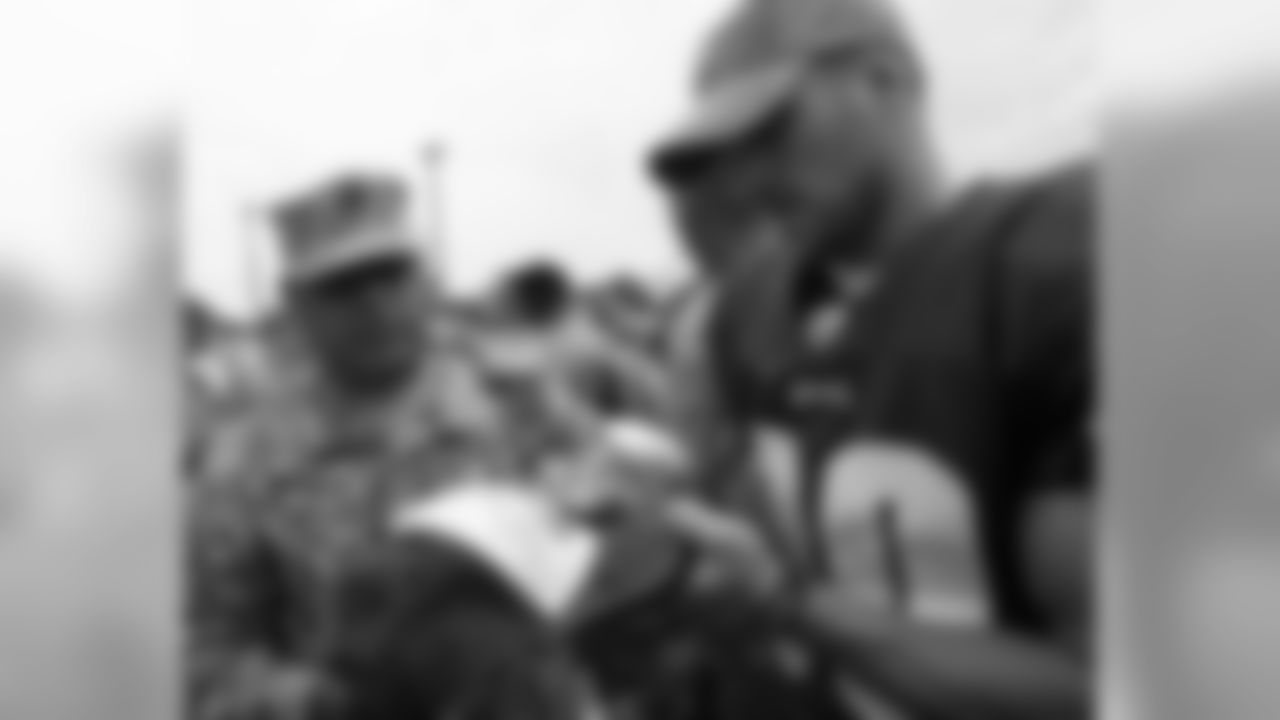 WR Kevin Curtis signs a hat for a member of the military