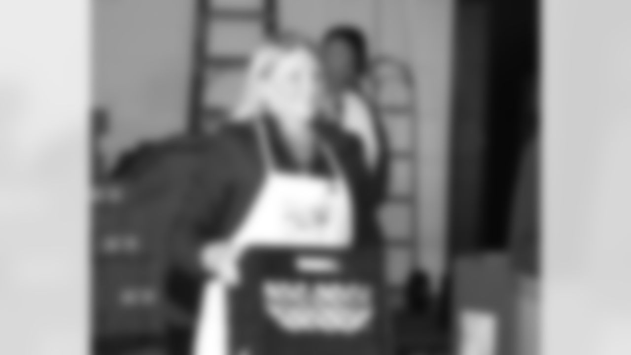 Tammy Reid, wife of Head Coach Andy Reid, helps distribute food to areas shelters at Philabundance