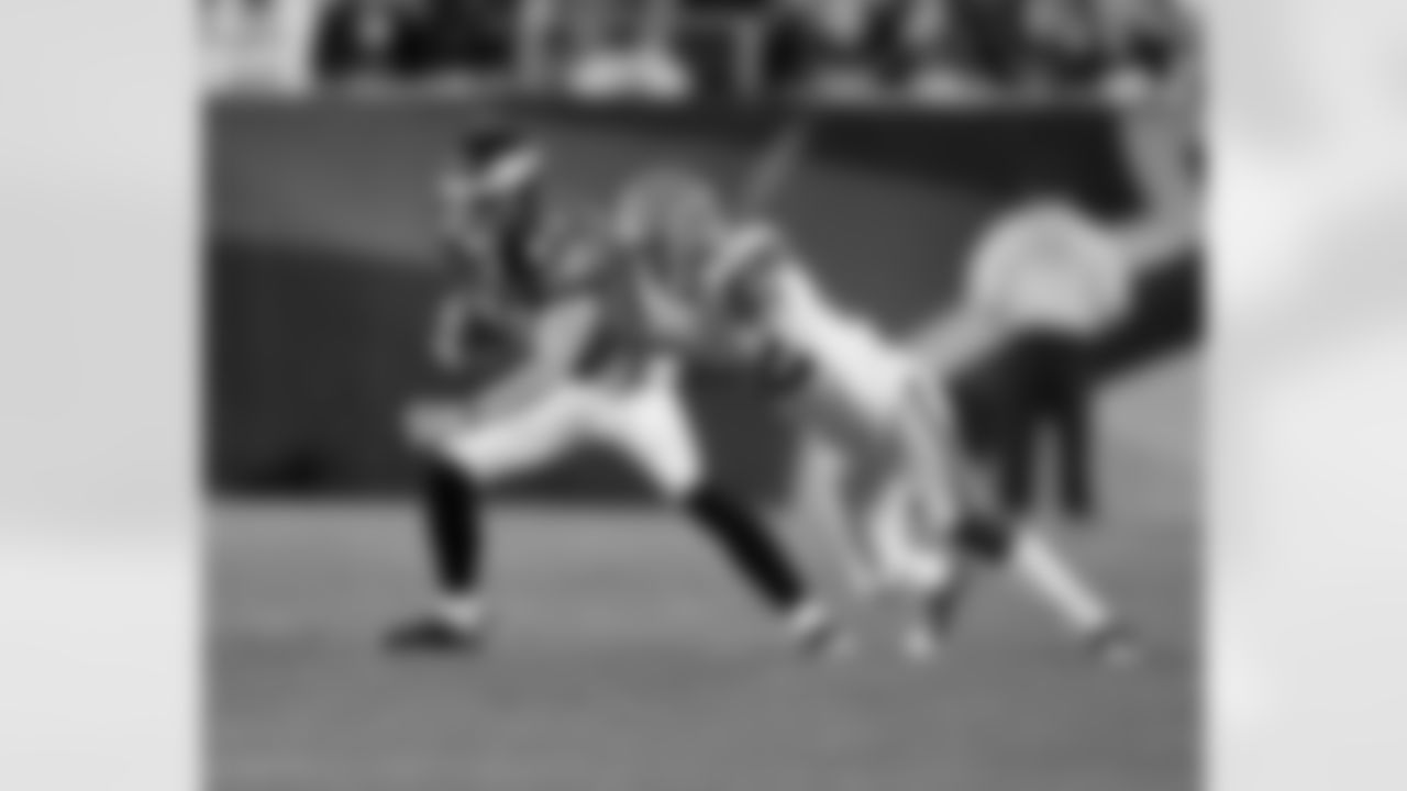 WR Kevin Curtis tries to shake loose from a tackle