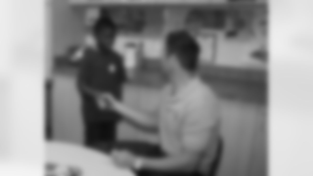 Feeley shakes the hand of a young man