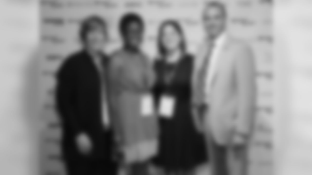 Eagles President Don Smolenski poses with members of Eagles Youth Partnership, including Korinne Dennis, who was recently named a Beyond Sport Young Ambassador.