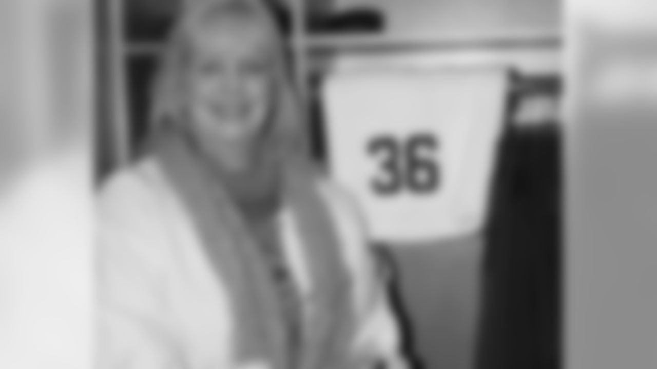 Woman poses inside RB Brian Westbrook's locker stall