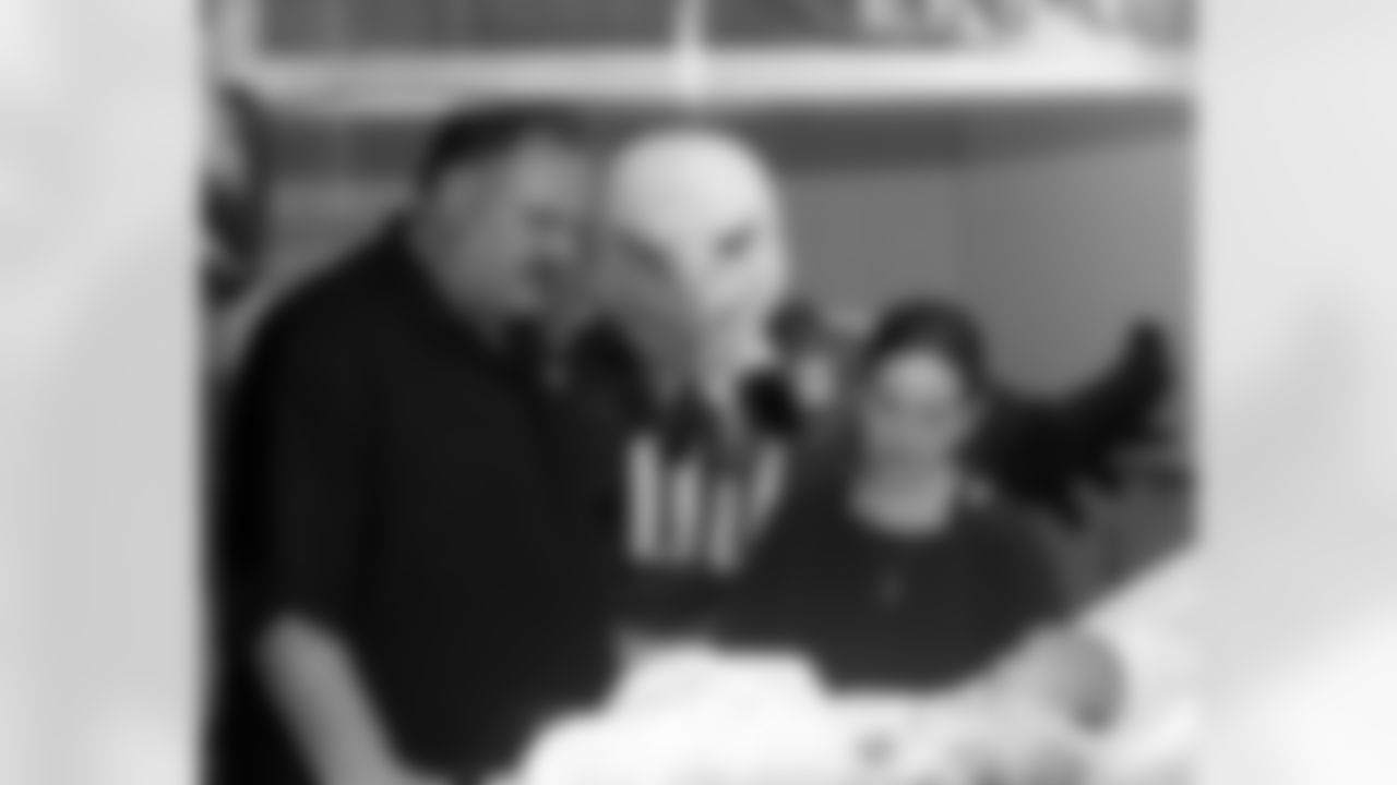 Head coach Andy Reid and SWOOP look in on a little baby