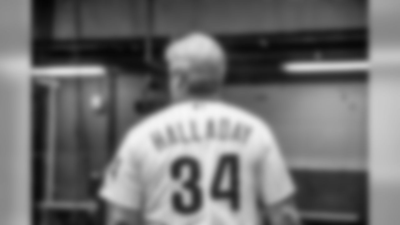 Coach Pederson wearing the jersey of late Phillies pitcher Roy Halladay.