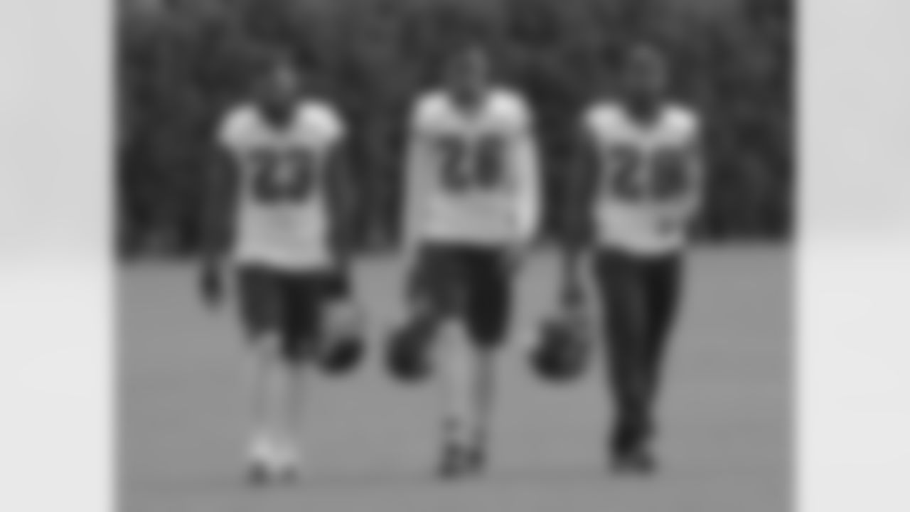 Some of the defensive backs walking back to the locker room after practice