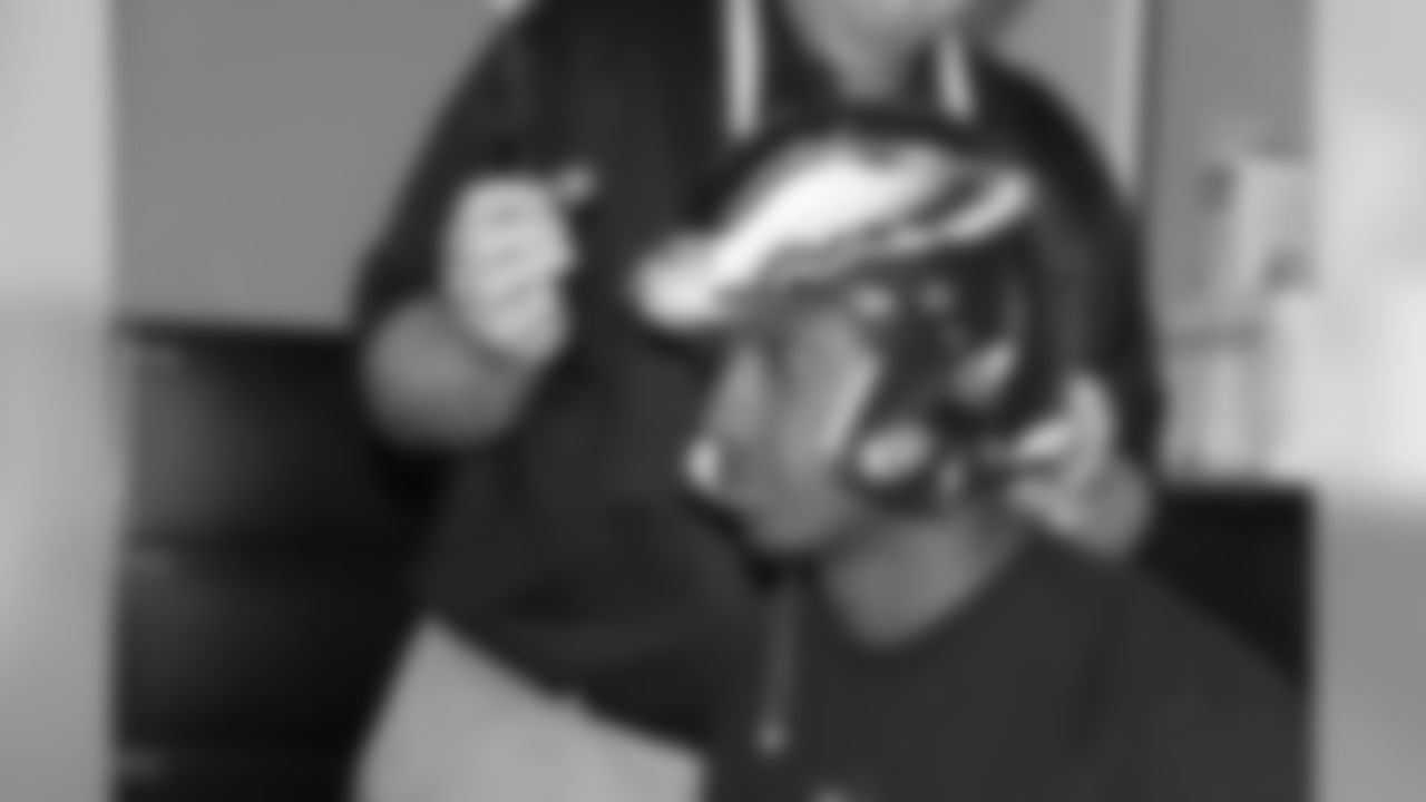 Adjustments are made to Brandon Boykin's helmet