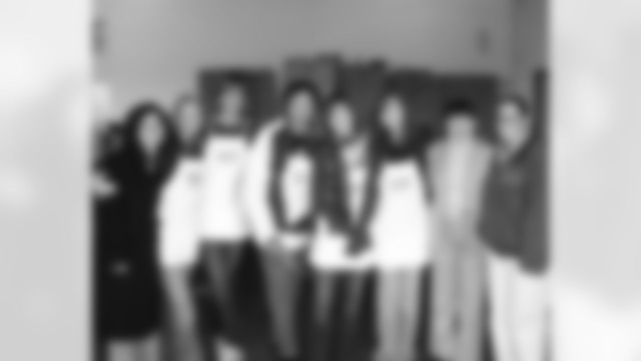 The coach's families pose with Philabundance members