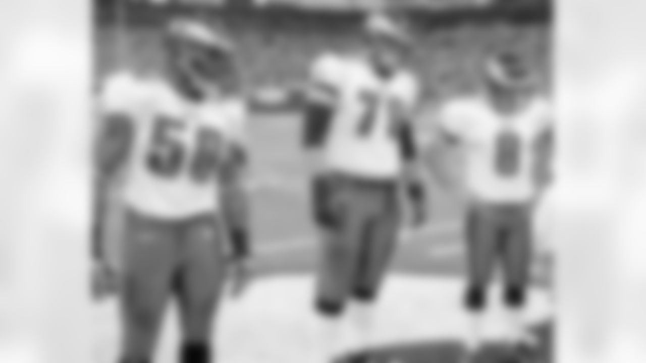 Trent Cole, Todd Herremans and Dirk Johnson wait for the coin toss